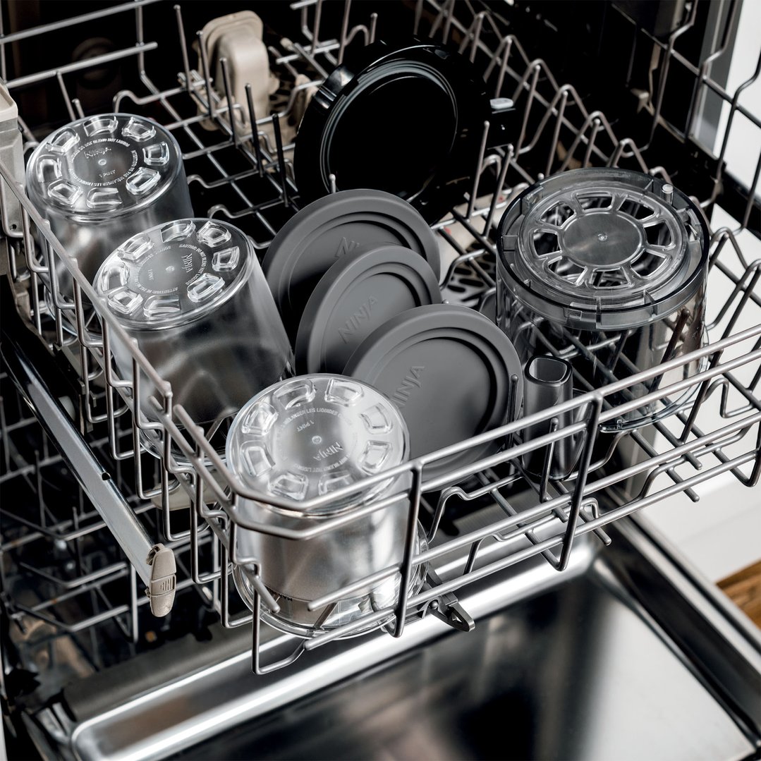 Ninja Creami tubs and lids in a dishwasher rack