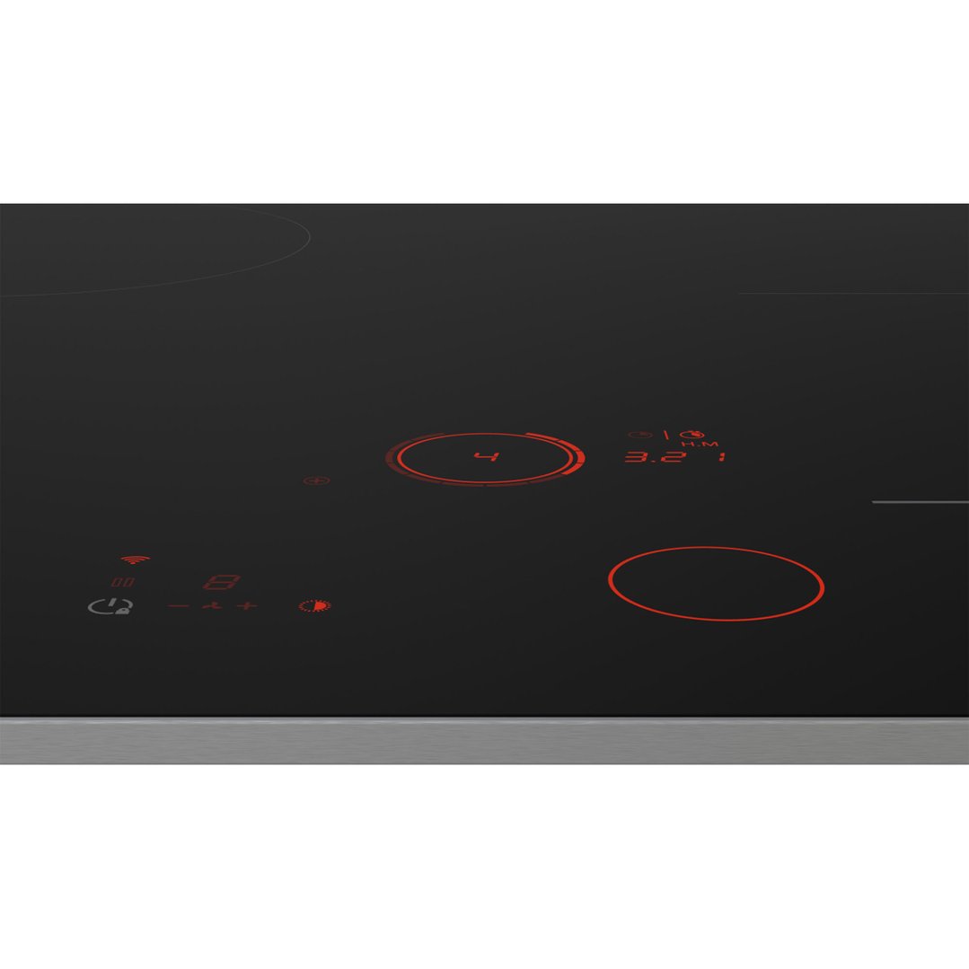 Close up of an induction cooktop with illuminated controls