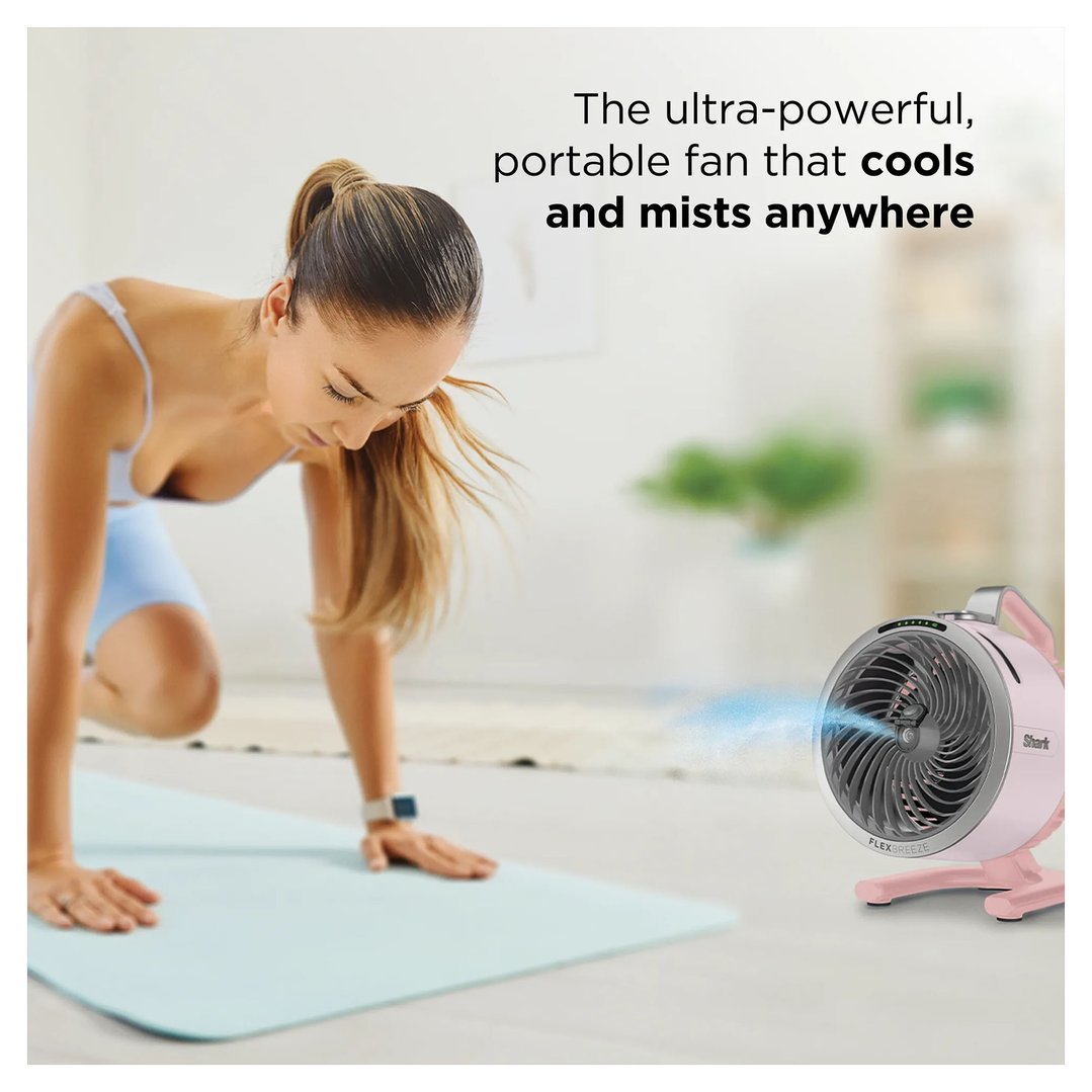Woman exercising on a mat with a pink portable fan misting beside her