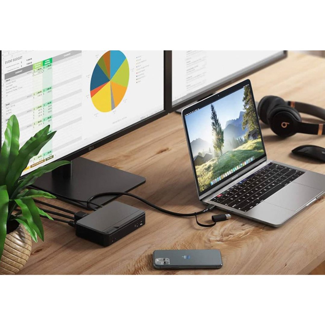 Universal Pro Docking Station connected to a laptop and monitors on a wooden desk