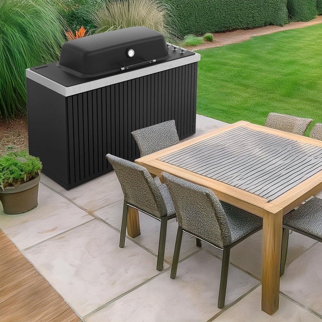 Black built-in barbecue on a patio next to an outdoor dining table