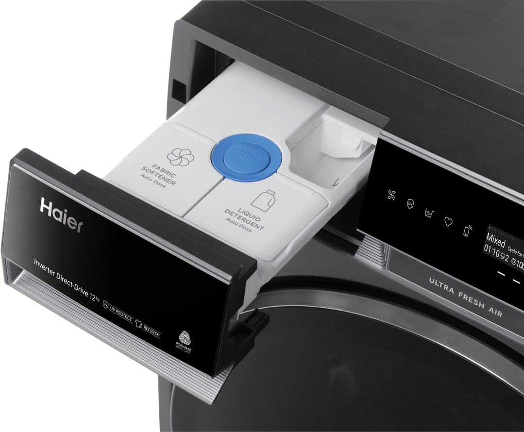 Close-up of a Haier washing machine's open detergent dispenser and control panel