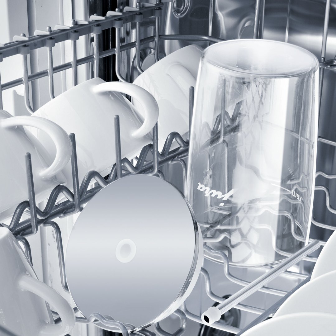 Glass milk container and other dishes in a dishwasher rack