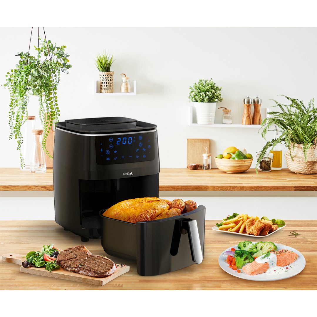 TEFAL Easy Fry Grill & Steam XXL Air Fryer in a kitchen setting with food