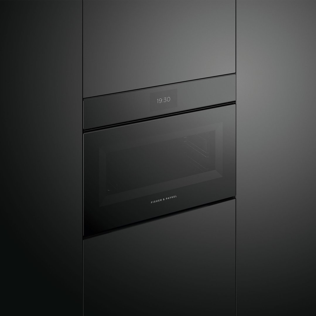 Black Fisher & Paykel compact combi-microwave oven built into dark cabinetry