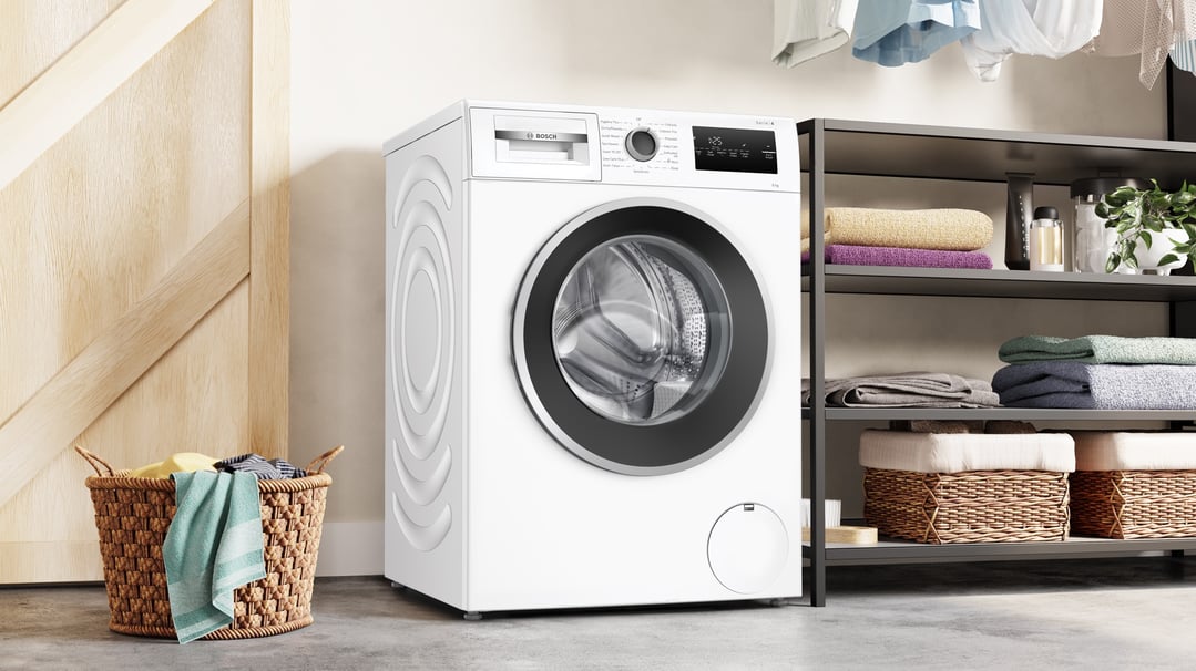 White Bosch front loader washing machine in a laundry room