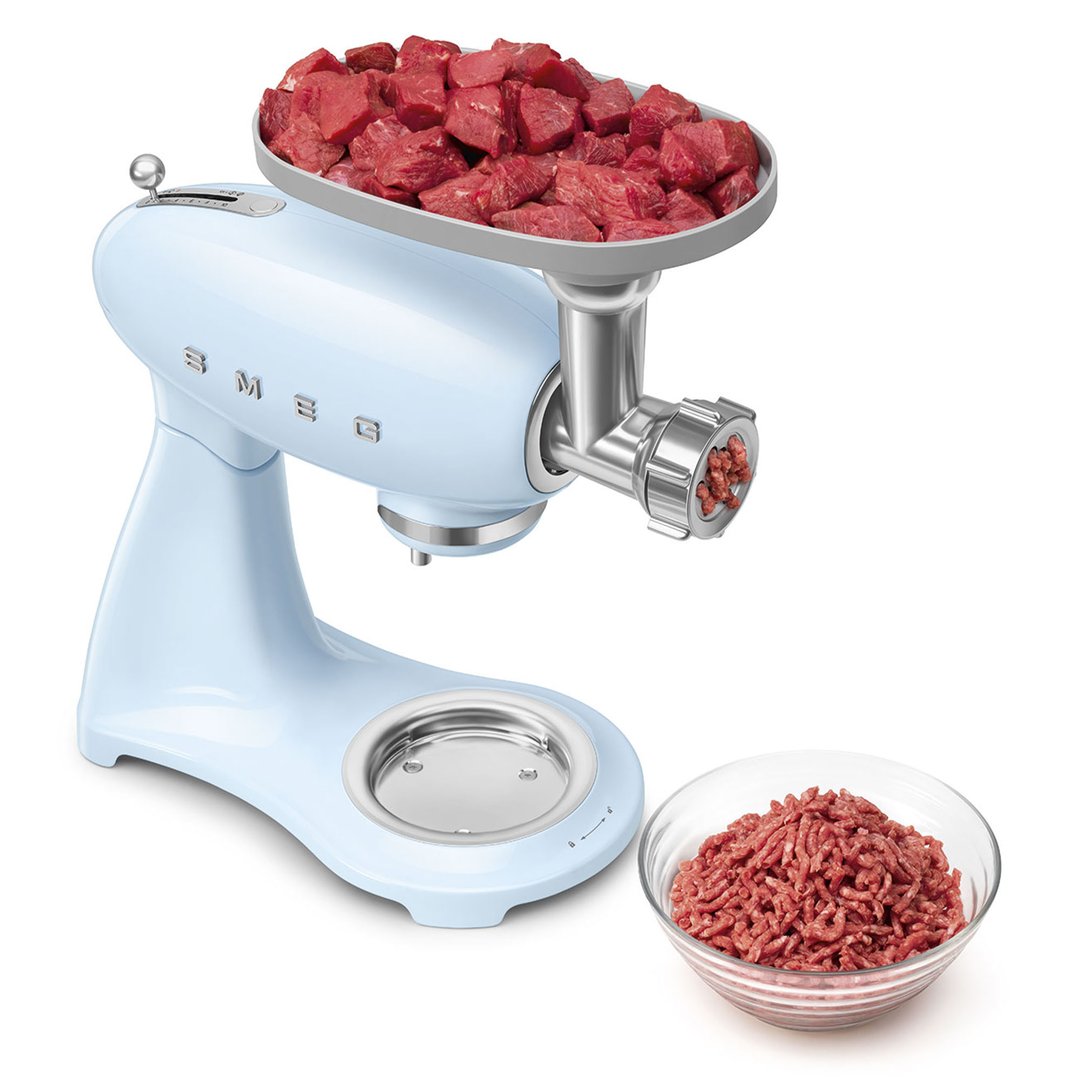 Pastel blue stand mixer with meat grinder attachment processing raw meat