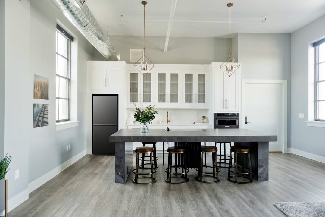 Matte black bottom mount fridge in a modern kitchen with a large island