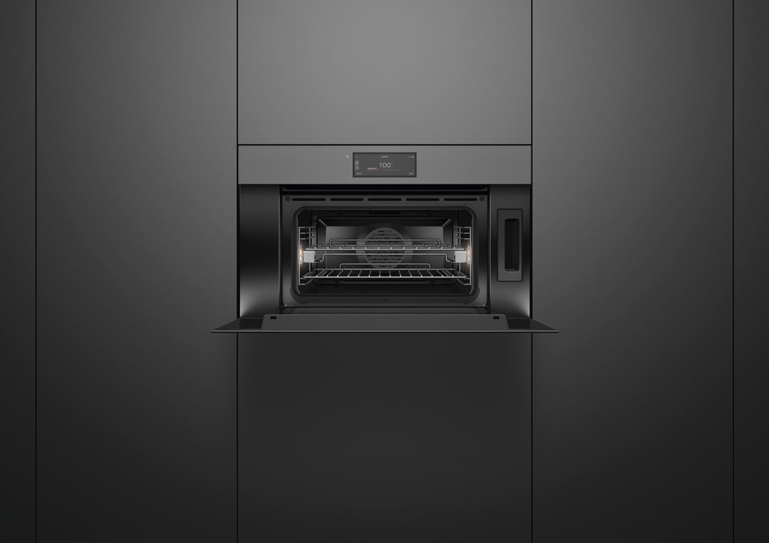Open grey glass combi-steam oven built into dark grey cabinetry