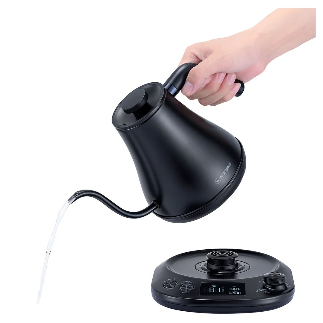 Hand pouring water from a black gooseneck kettle with a digital base