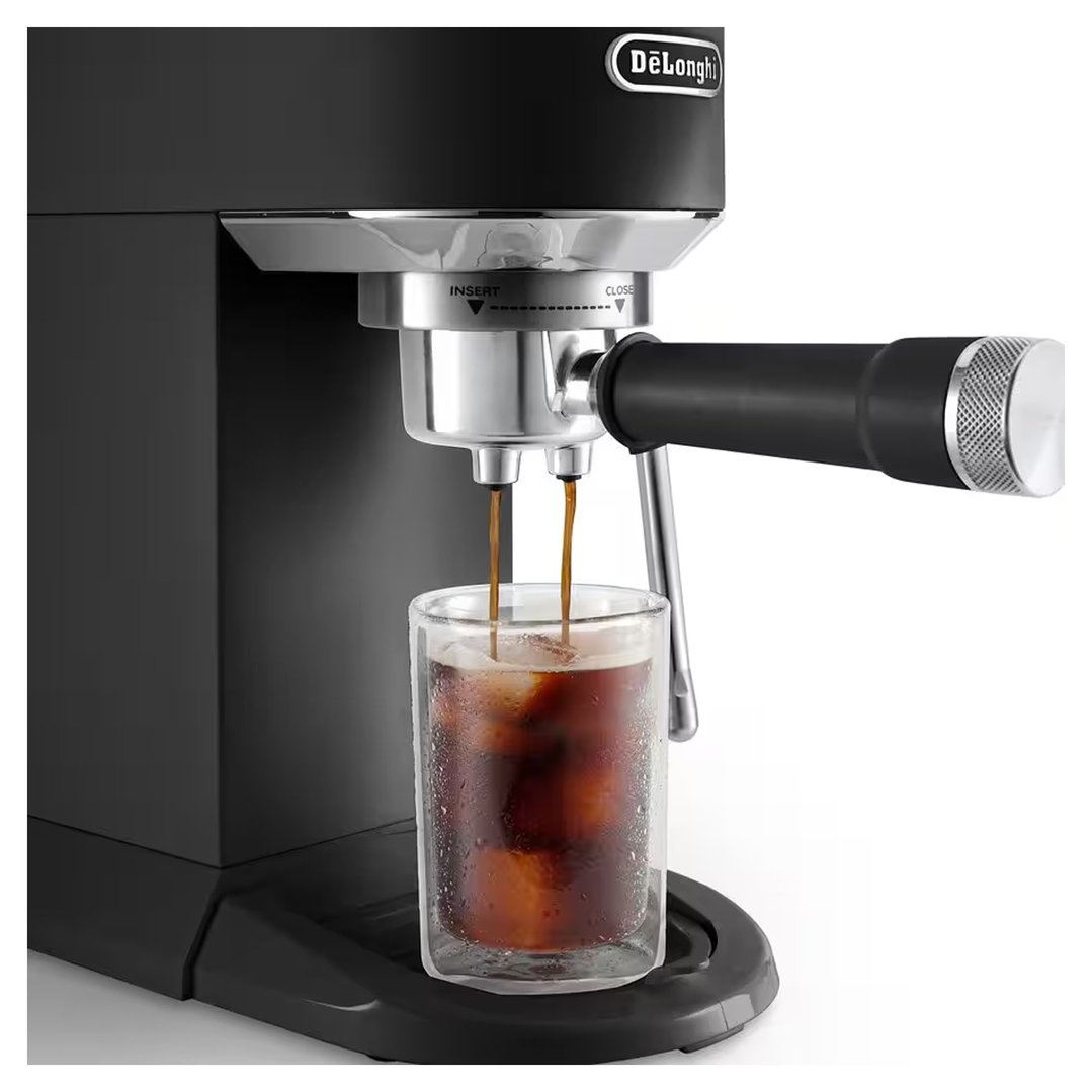 Black coffee machine dispensing coffee into a glass with ice