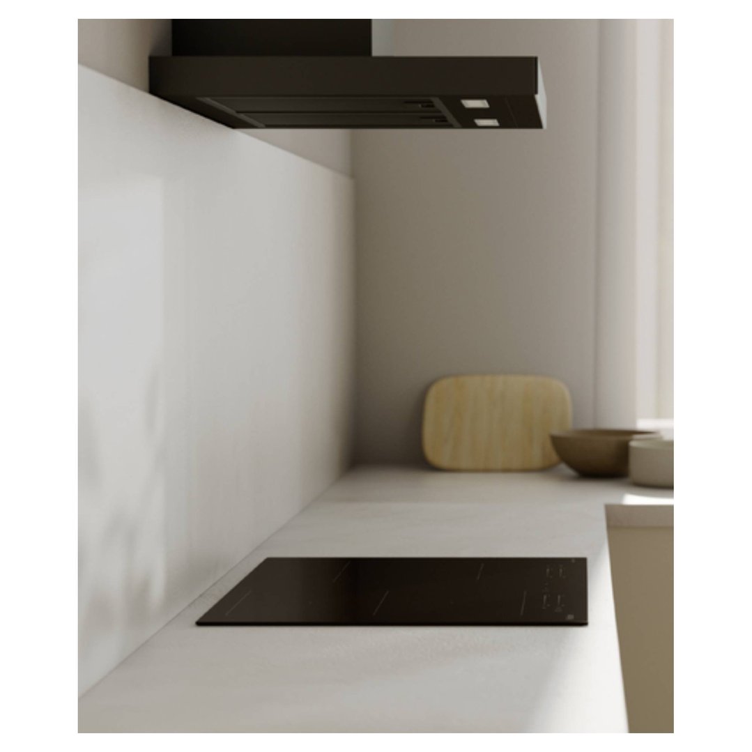 Black induction cooktop in a modern kitchen with a range hood above