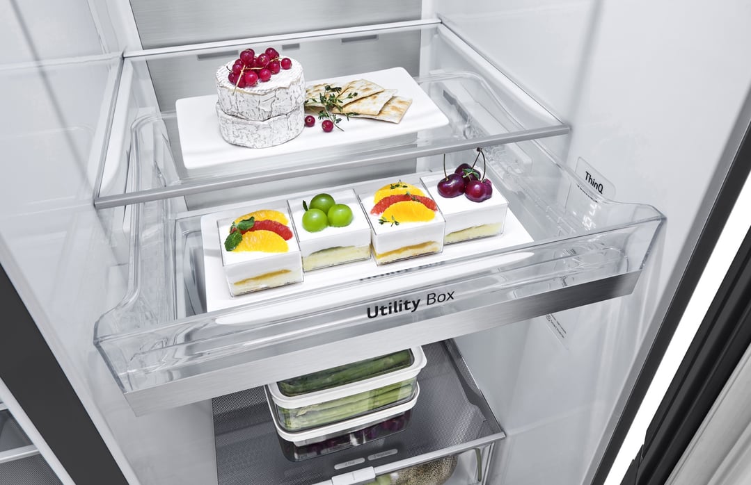 Inside a fridge showing various food items on shelves and in the utility box