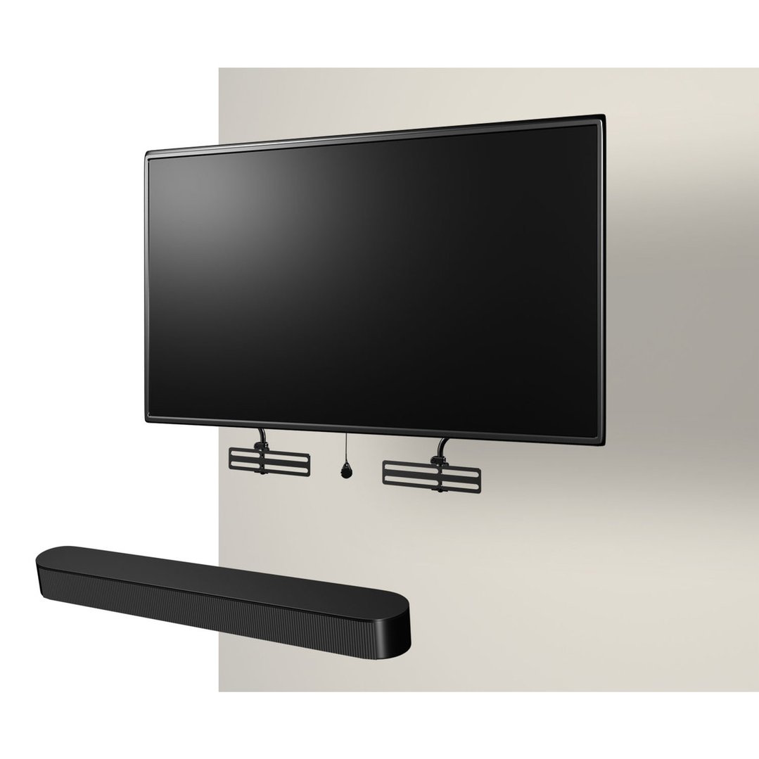 A sound bar mount holding a sound bar below a wall-mounted TV