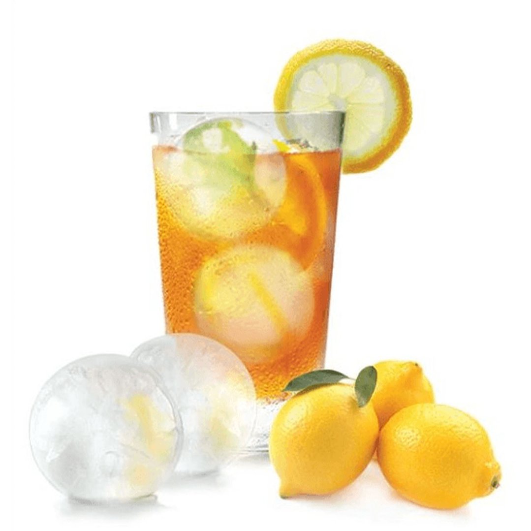 Sphere ice makers and lemons next to a glass of iced tea