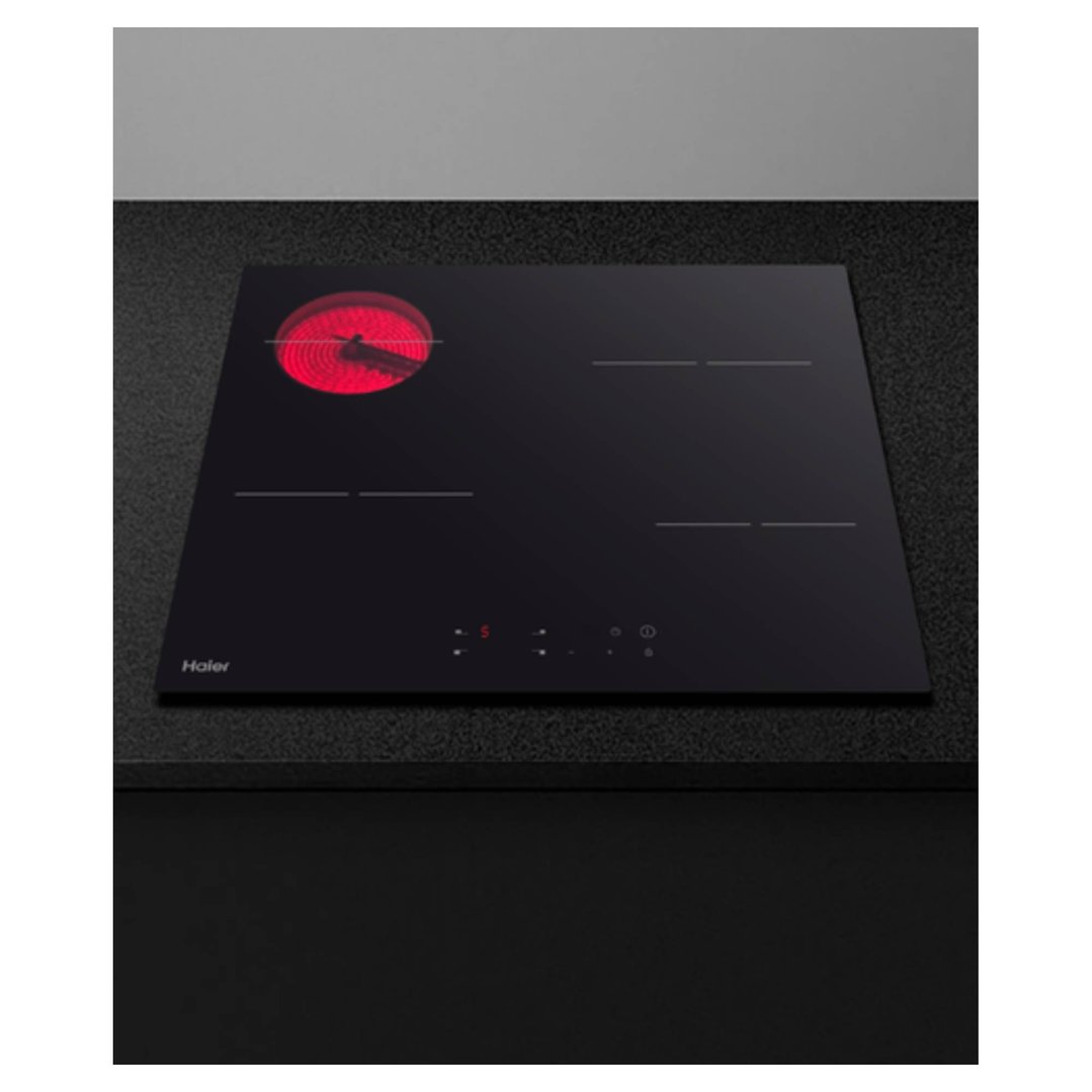 Haier 60cm electric cooktop with one red hot zone on a dark countertop