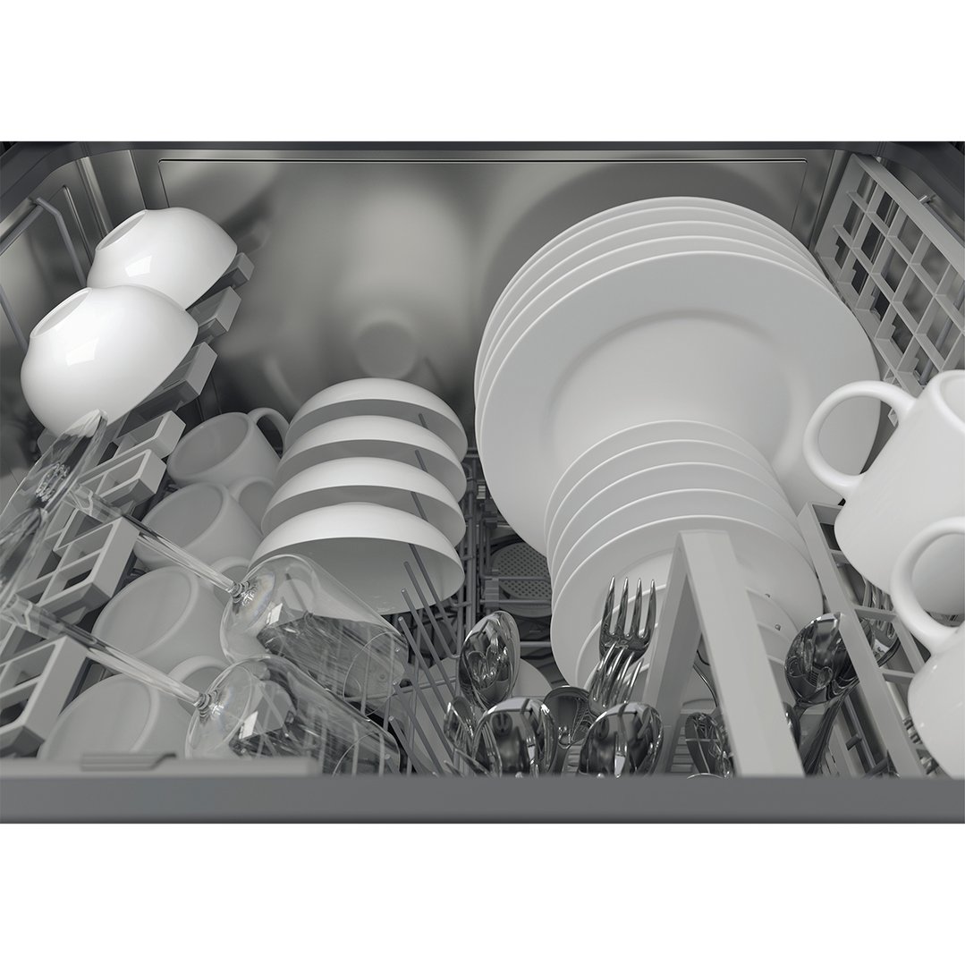 Close up of a dishwasher interior filled with white dishes, glasses, and cutlery