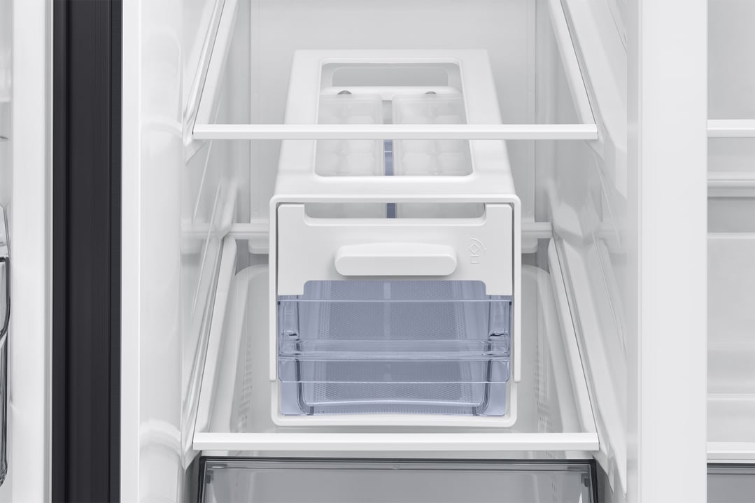 Interior view of a refrigerator showing the ice maker and storage bins