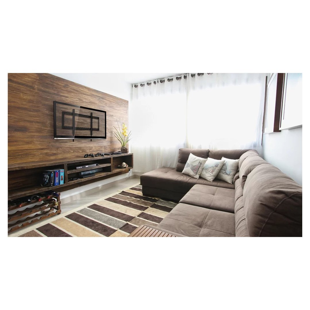A tv wall mount installed on a TV in a living room with a brown sofa