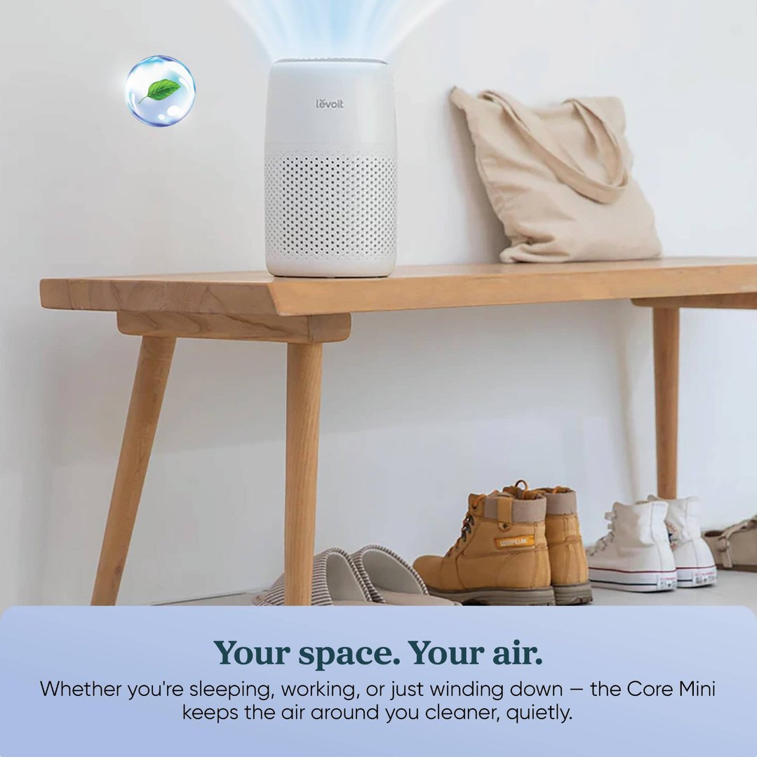 LEVOIT Core Mini Air Purifier on a wooden bench with shoes and a bag