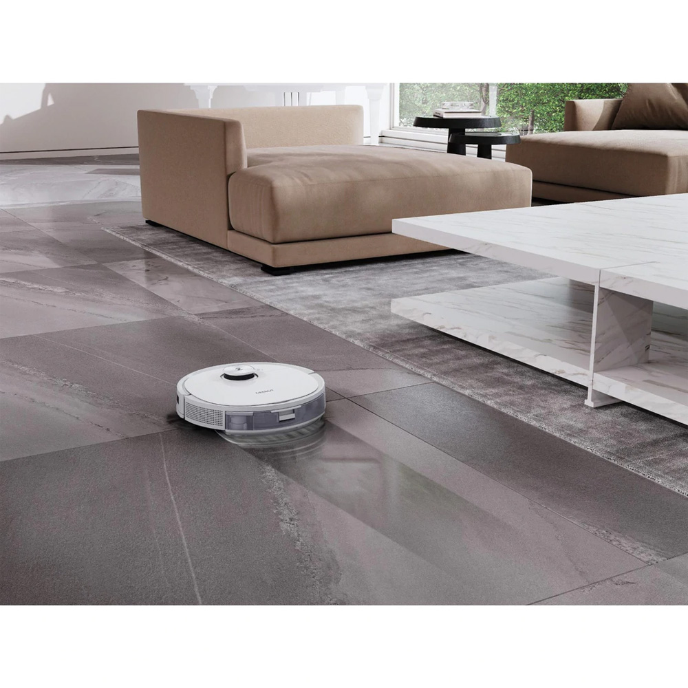 ECOVACS robotic vacuum cleaning a tiled floor in a modern living room