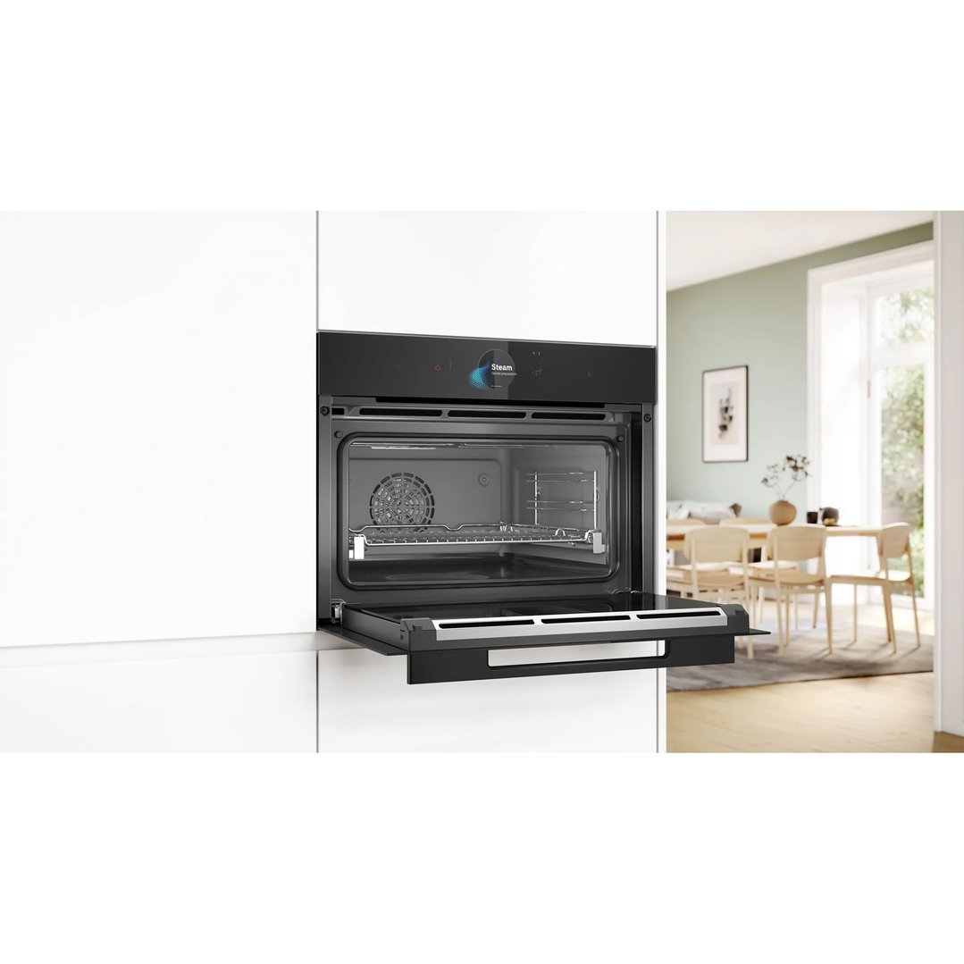 Built-in compact oven with steam function in a modern kitchen setting