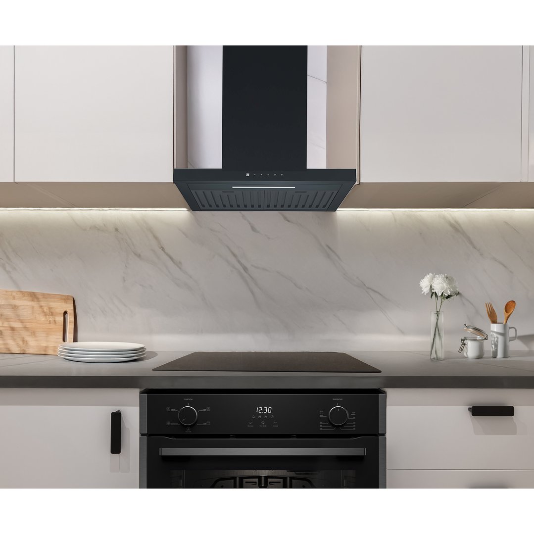 Matte black rangehood installed above a cooktop in a modern kitchen