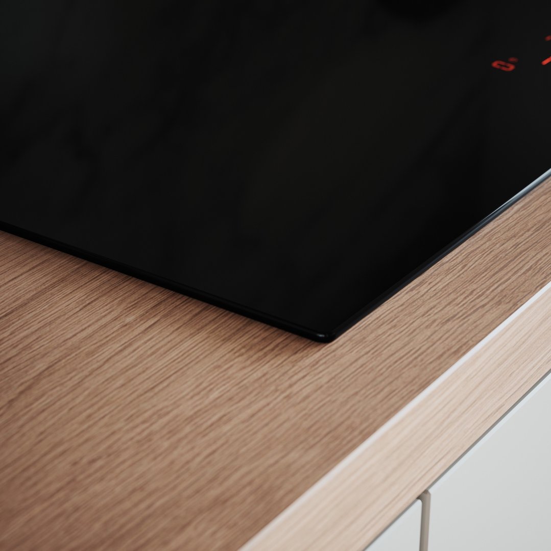 Close up of an induction cooktop installed in a wooden countertop