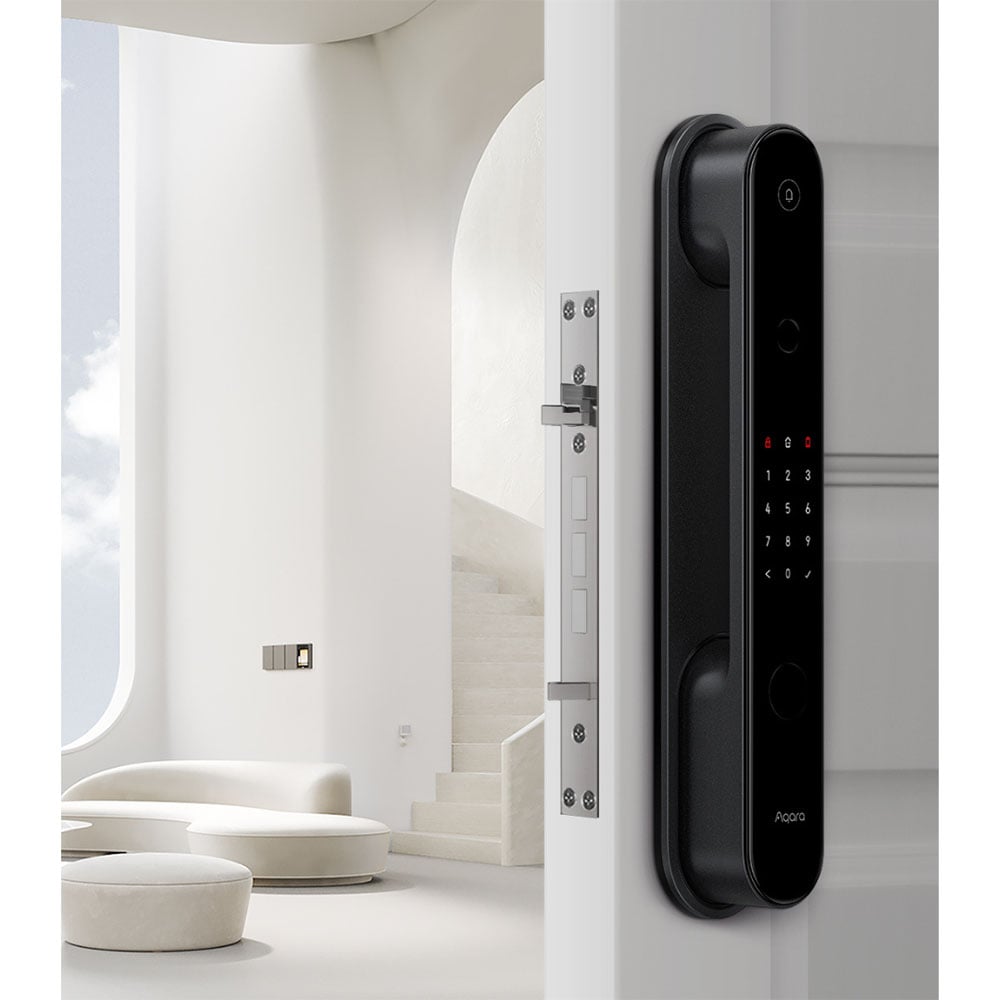 Black smart digital door lock on a white door in a modern interior