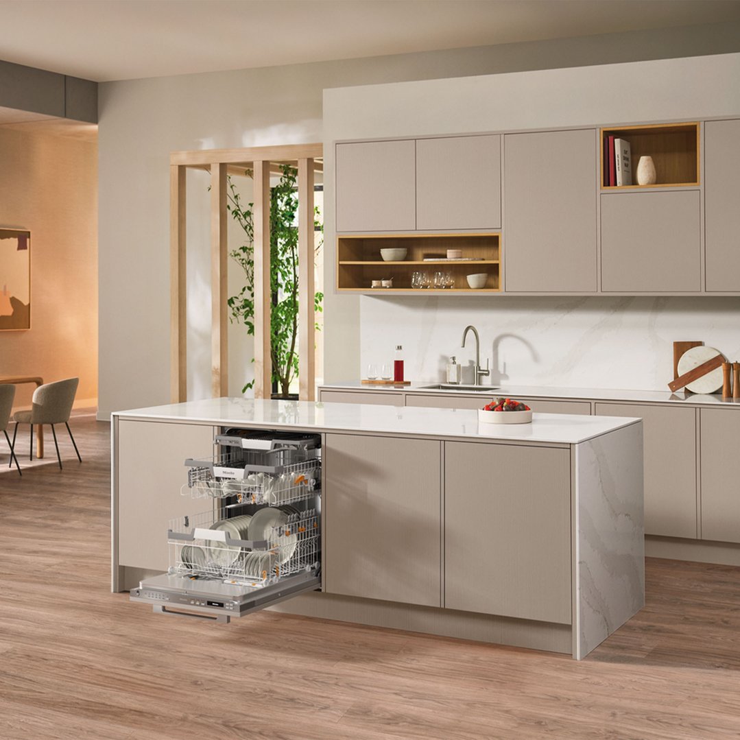 Fully integrated dishwasher with racks pulled out in a modern kitchen island