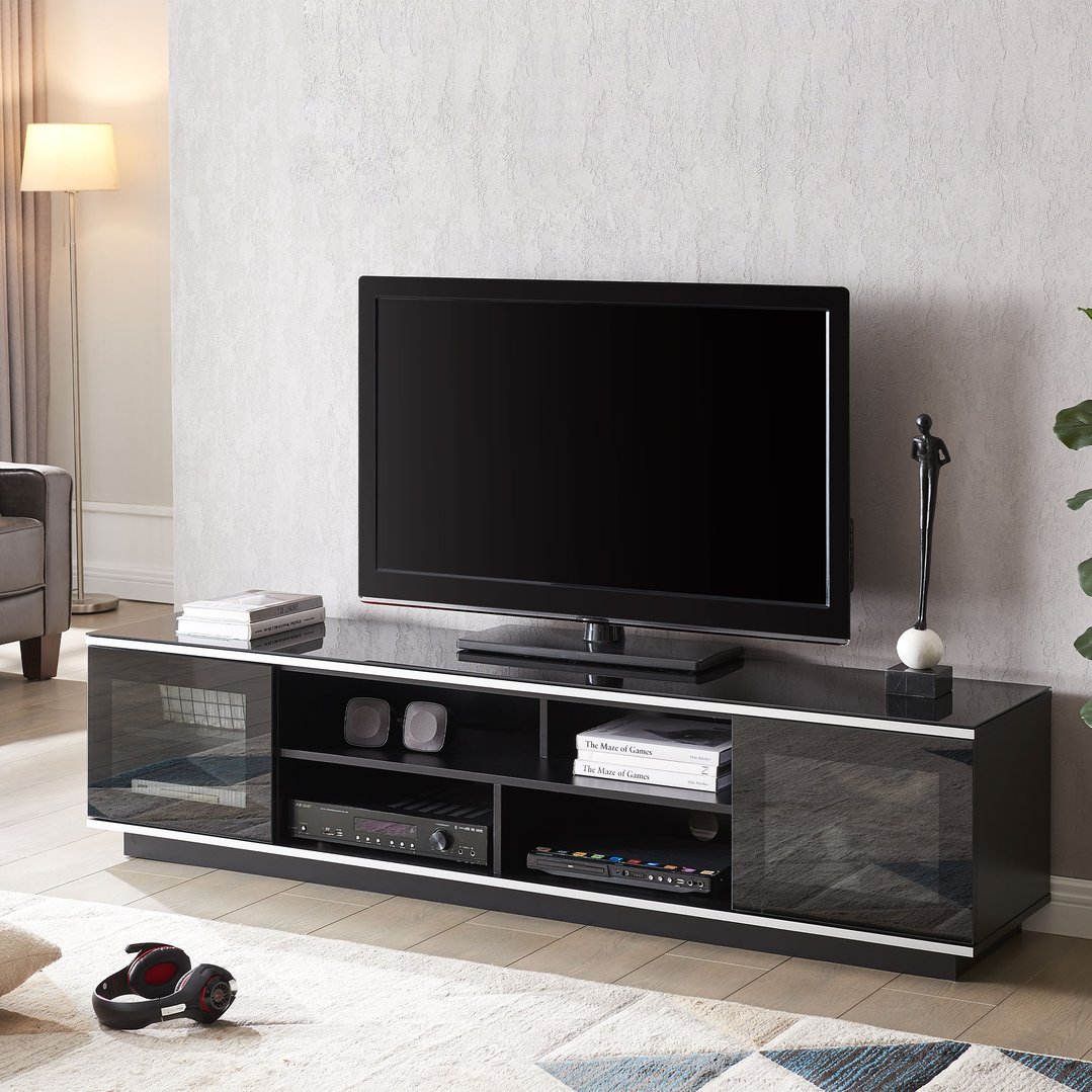 Black TV cabinet with a TV and decor in a living room setting