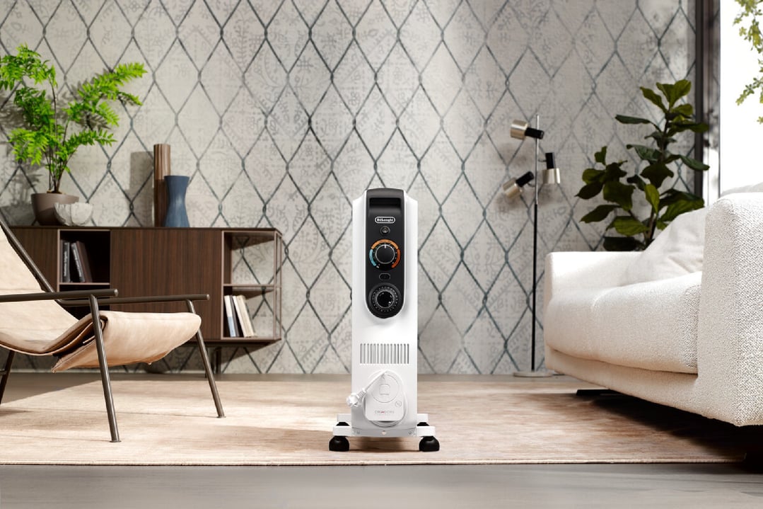 Oil column heater in a living room with furniture and plants
