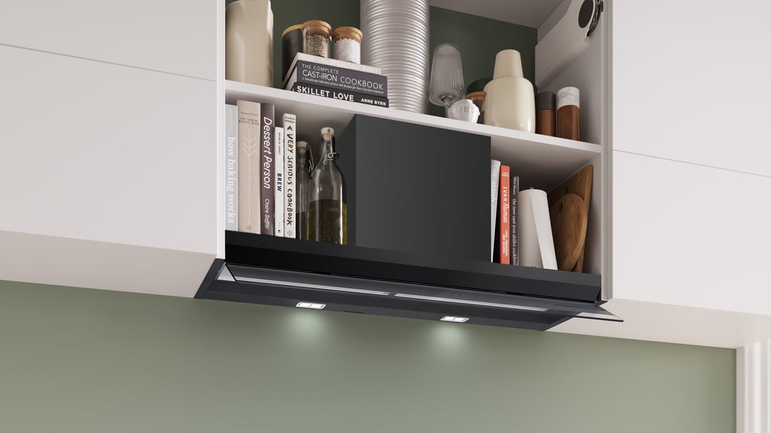 Integrated rangehood with lights on, installed under a kitchen cabinet