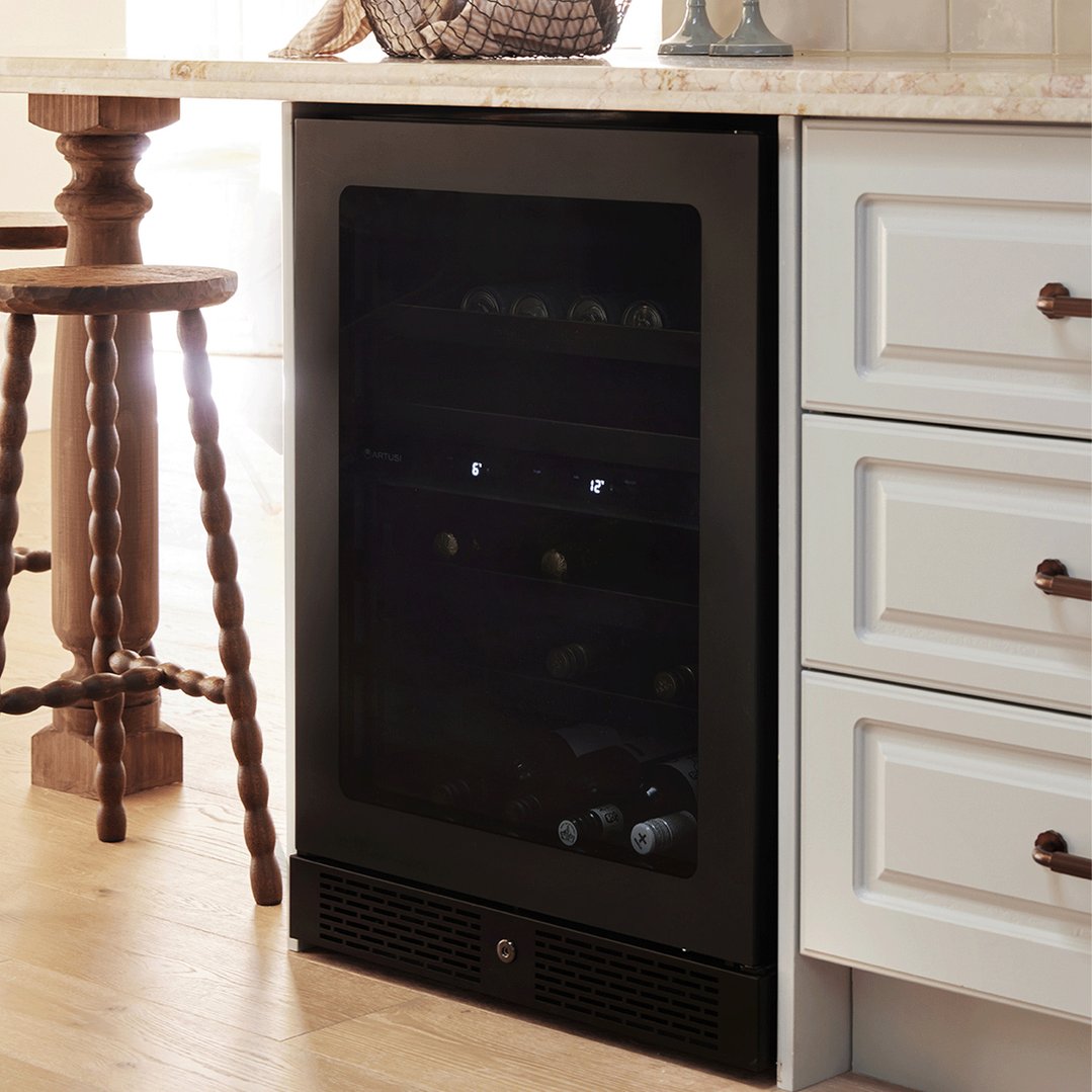 Black wine cooler built into a kitchen counter next to white cabinets