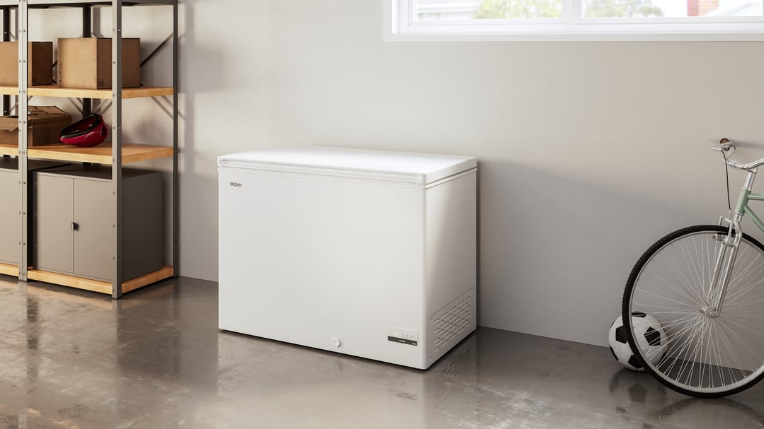Haier 301L chest freezer in a garage with shelving and a bicycle