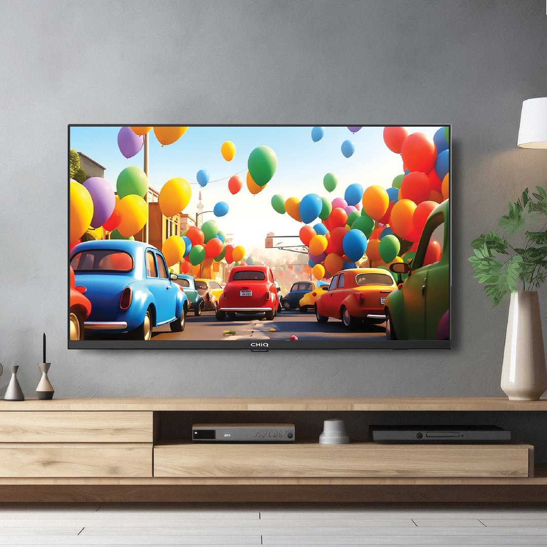 CHIQ TV displaying a colorful street scene, on a wooden entertainment unit