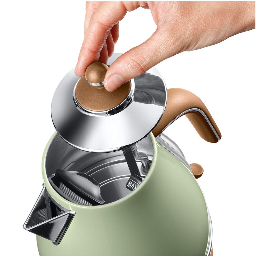 Hand opening the lid of a green DeLonghi electric kettle