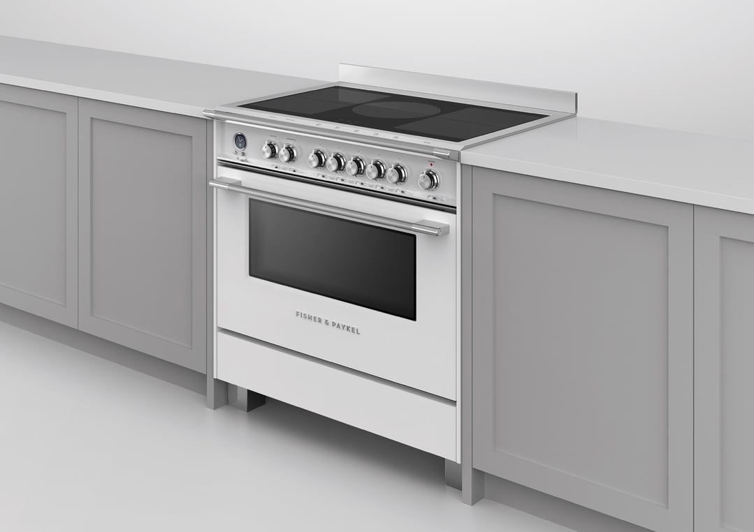 White induction pyrolytic cooker with black cooktop built into a grey kitchen cabinet