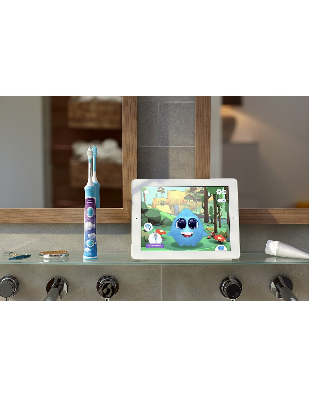 Sonicare For Kids electric toothbrush and tablet on a bathroom shelf