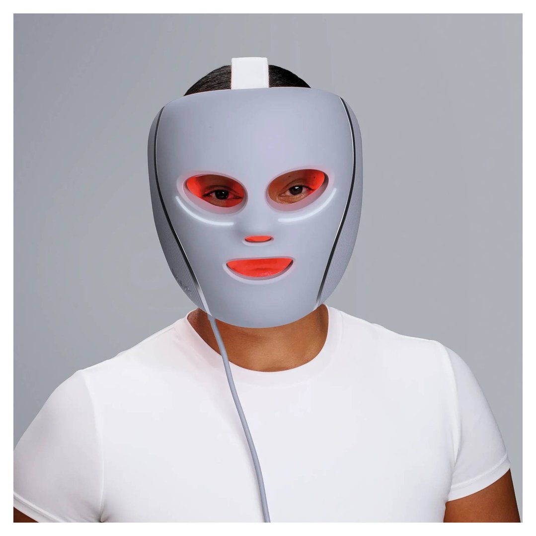 Person wearing a CryoGlow Under-Eye Cooling + LED Face Mask with red lights