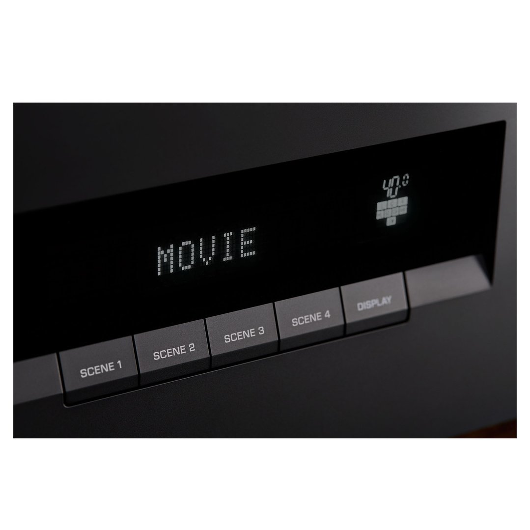 Close up of an AV receiver's display showing "MOVIE" and scene buttons