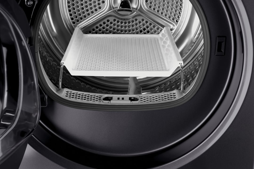 Close up of the inside of a washer heat pump dryer drum with a drying rack