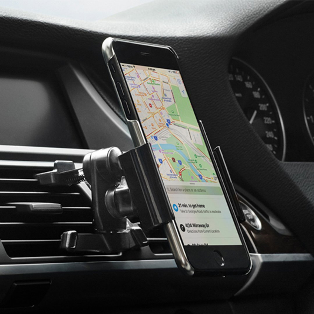 Smartphone in a car mount attached to an air vent in a car interior