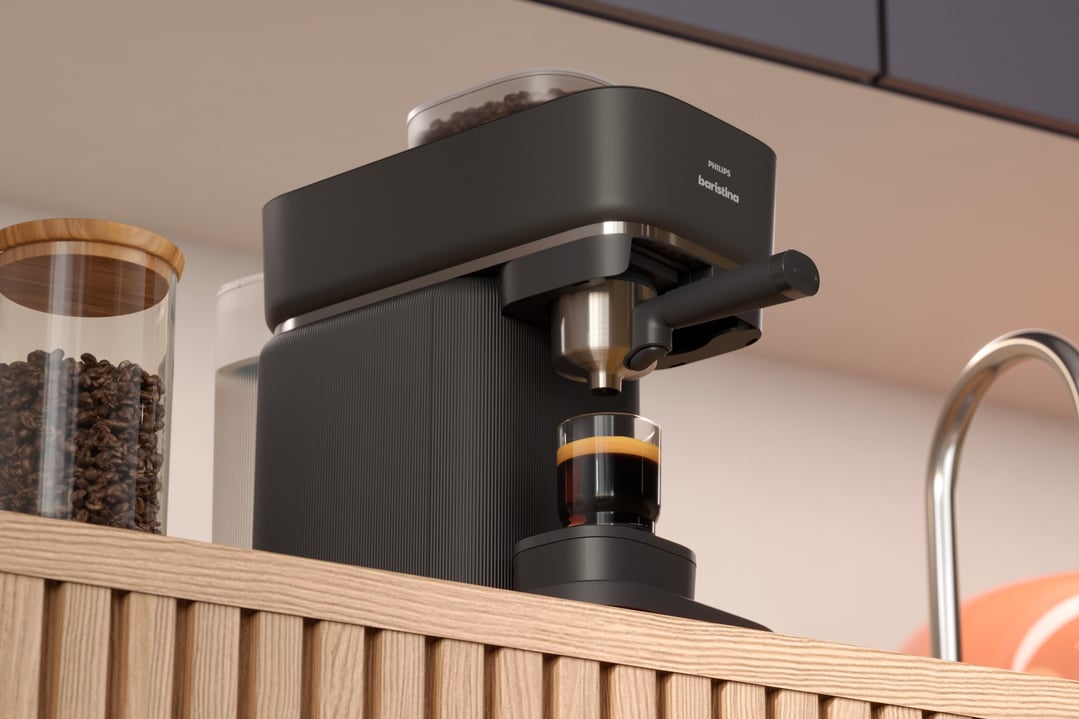 Black espresso machine making coffee in a glass on a wooden counter