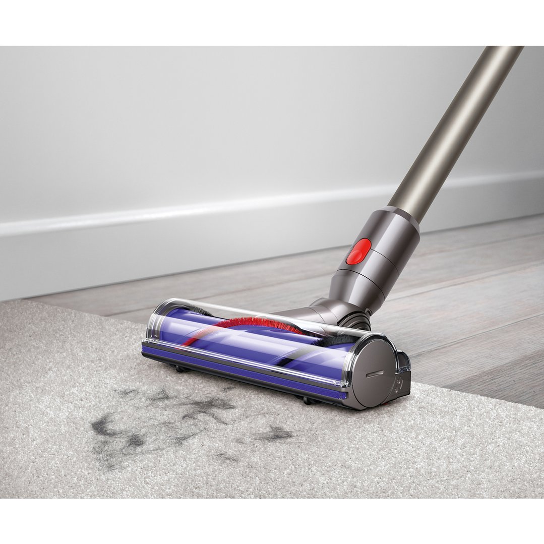 Dyson V8 Animal Handstick Vacuum cleaning dirt from a grey carpet