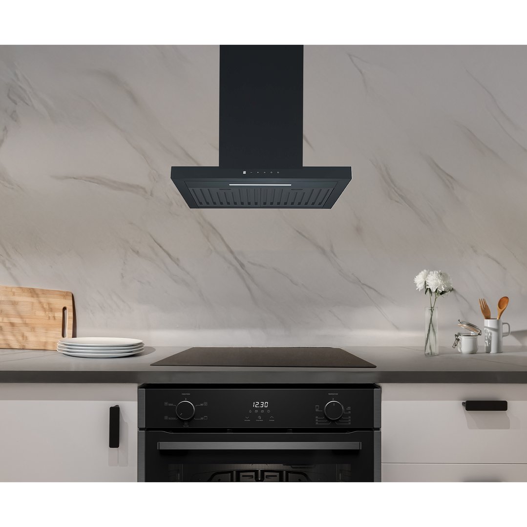 Black rangehood and oven in a modern kitchen with white marble backsplash