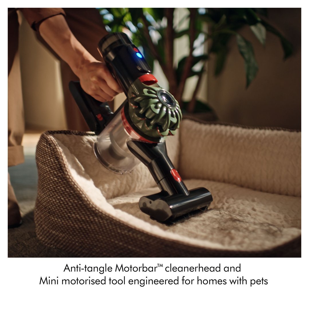 Handheld DYSON handStickVacuum cleaning a pet bed with a mini motorised tool