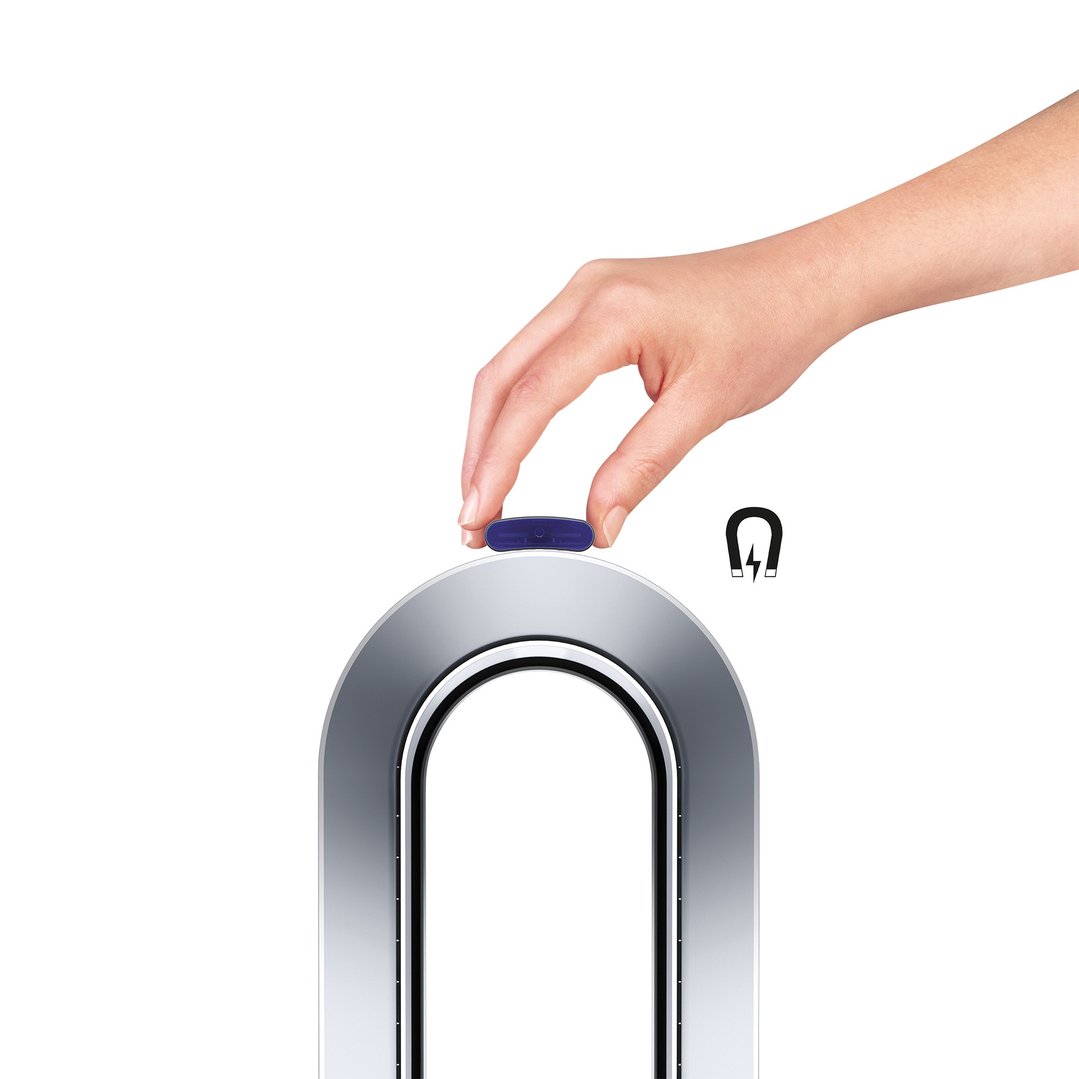 Hand placing a blue magnetic remote control on top of a Dyson air purifier