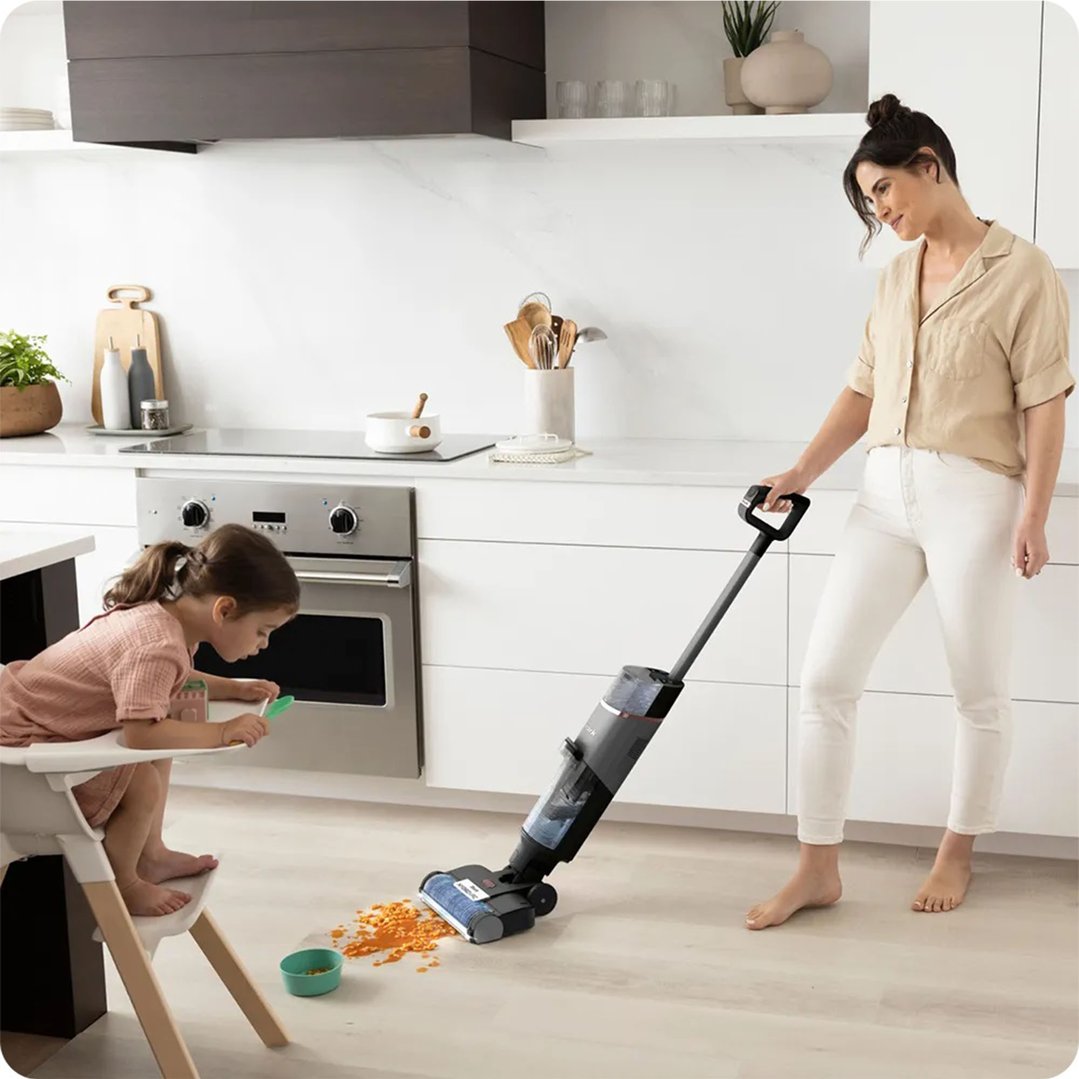 Woman using a Shark HydroVac Multi-surface Cleaner to clean a kitchen floor
