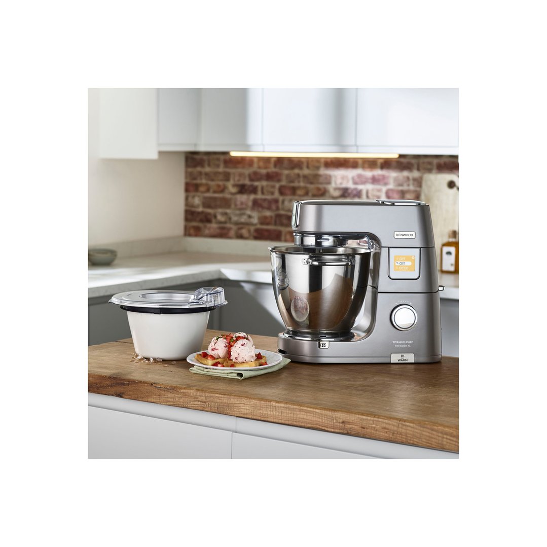 Frozen dessert maker attachment and stand mixer on a wooden kitchen counter
